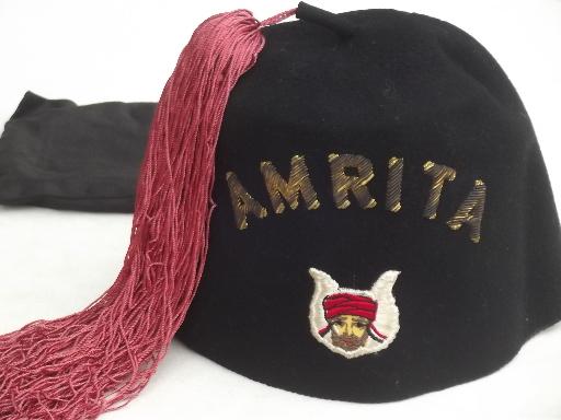 A black fez with a red tassel, the iconic headwear of the Grotto.